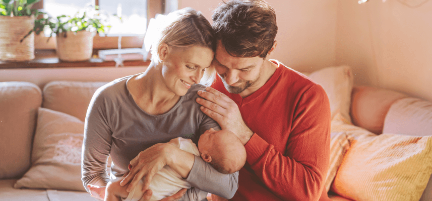 parents holding baby